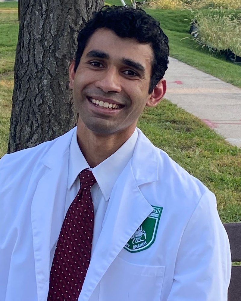 Lutfi Huq, MD/PhD candidate, in a white coat